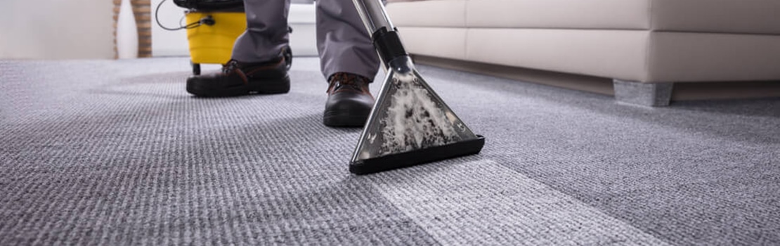 man vacuuming a carpet